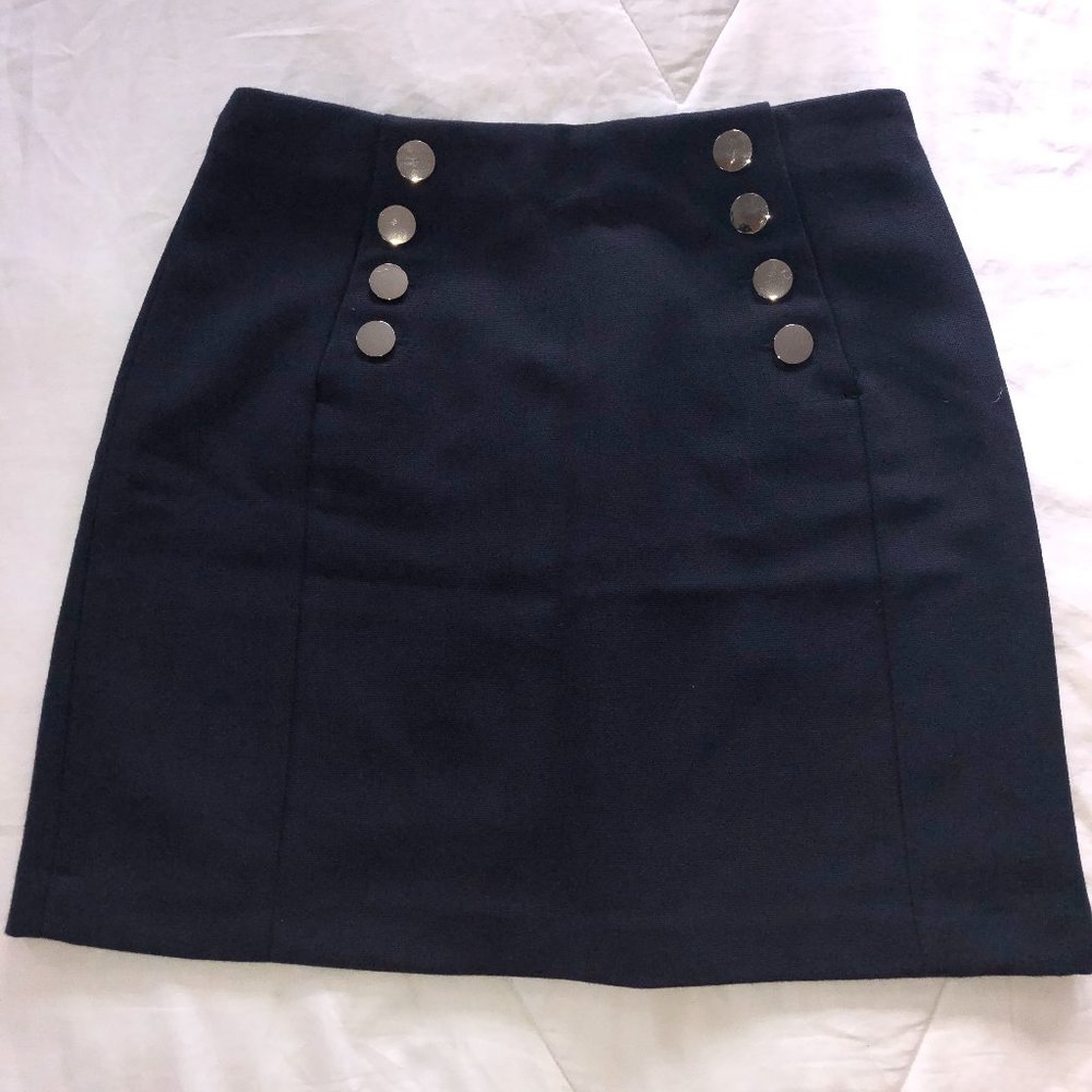 Navy colored mid-thigh length skirt.